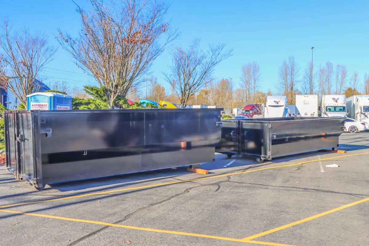 Professional dumpster rental service with roll-off container on residential driveway in Carpinteria